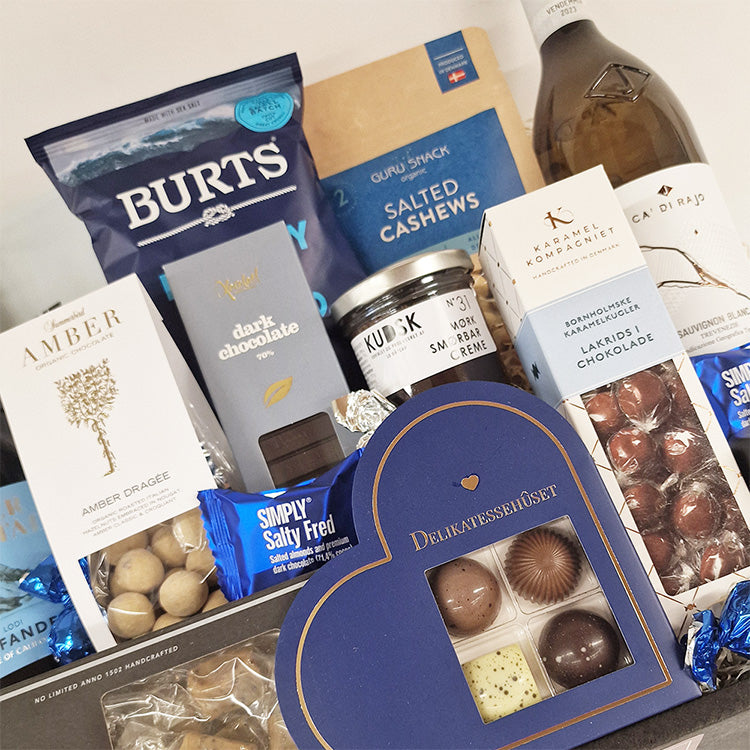 Gavekurv med hvidvin, chokolade, lakrids og snacks som en eksklusiv værtindegave eller firmagave.