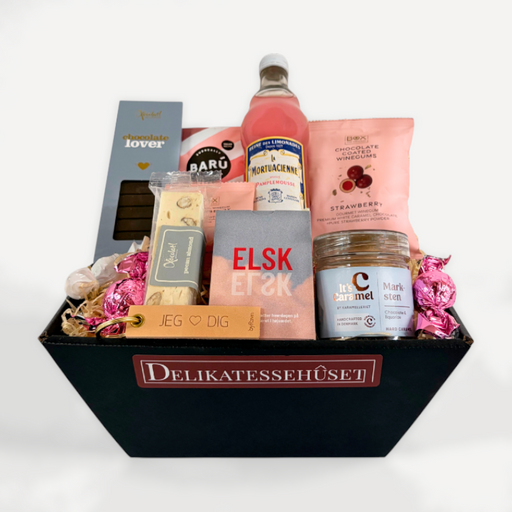 Lyserød gavekurv med forskellige lækkerier