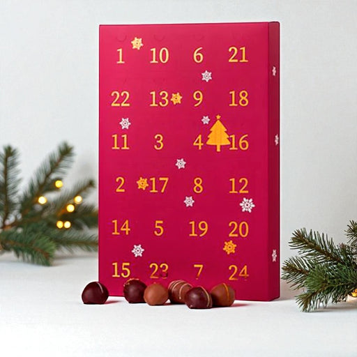 Julekalender med romkugler – 24 chokoladeovertrukne trøffelkugler med flydende karamel og 12 forskellige smagsvarianter. Perfekt gave til romkugle-elskere.