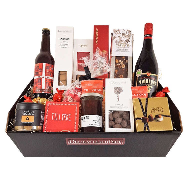 Stor rød tillykke gavekurv med rødvin, specialøl, lakrids, chokolade og marmelade fra Delikatessehuset.