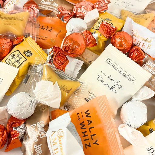 Storkøb af orange flowpacks, chokoladekugler. Ideel til kontoret, receptionen, mødelokalet eller festen.