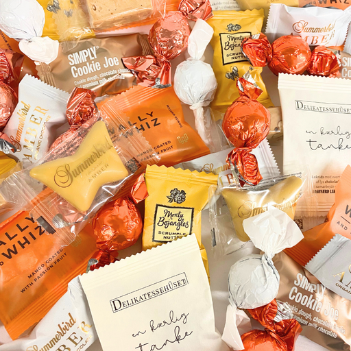 Storkøb af orange flowpacks, chokoladekugler. Ideel til kontoret, receptionen, mødelokalet eller festen.